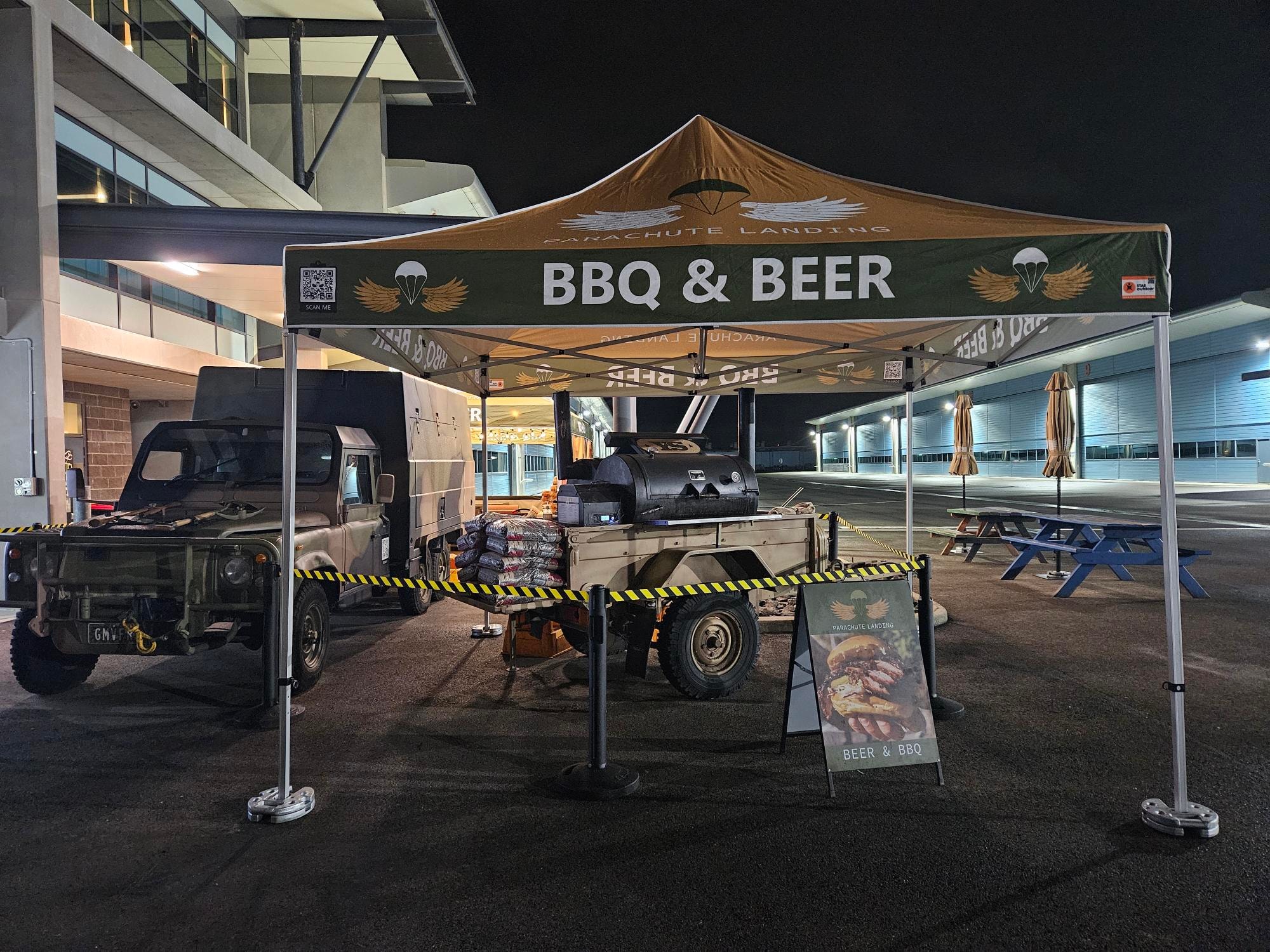 Parachute Landing BBQ & Beer setup on the tarmac at night