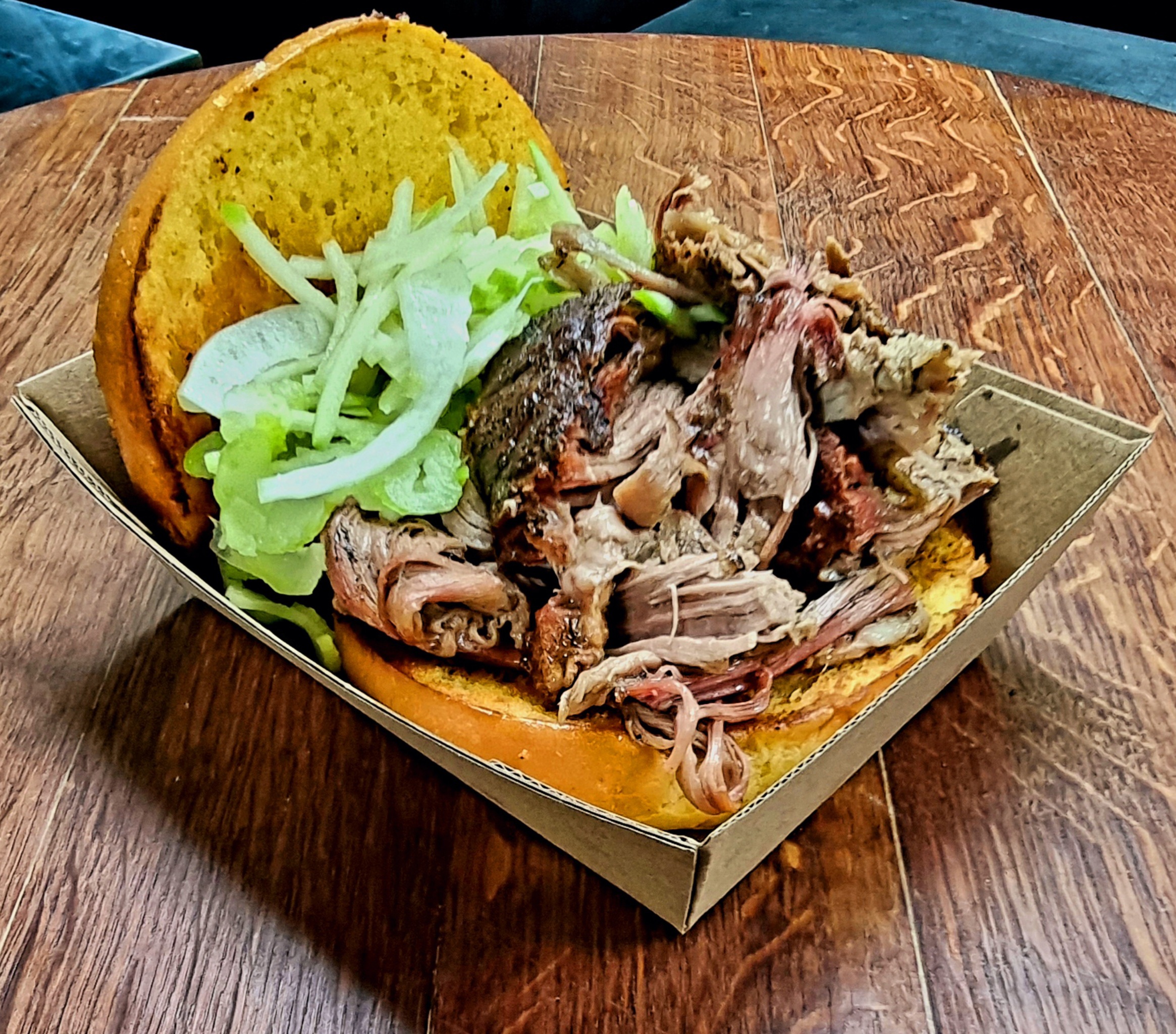 Parachute Landing pulled pork burger with apple slaw on a toasted brioche bun